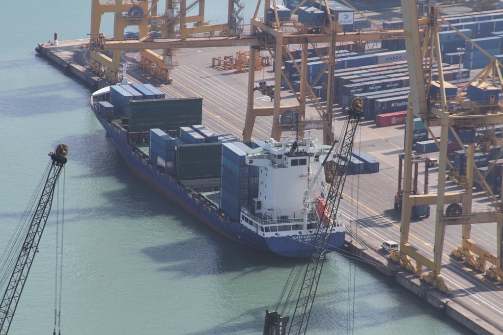 A container ship loading at a port terminal